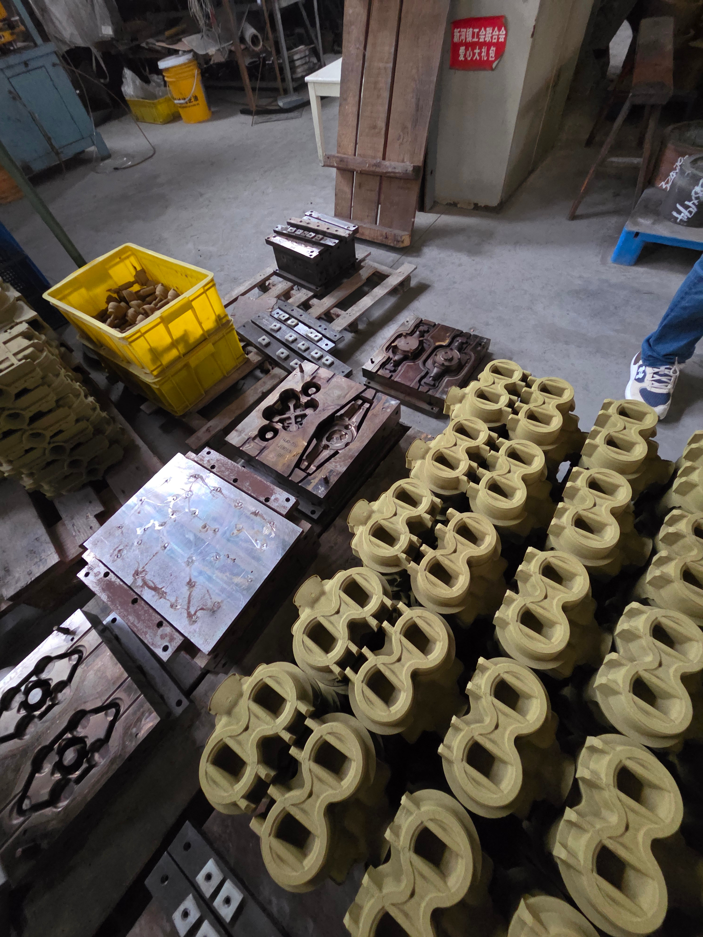 Sand-cast brass valve and fitting moulds on the foundry floor during a Global Supply Network supplier audit, Shanghai, China, 2025.