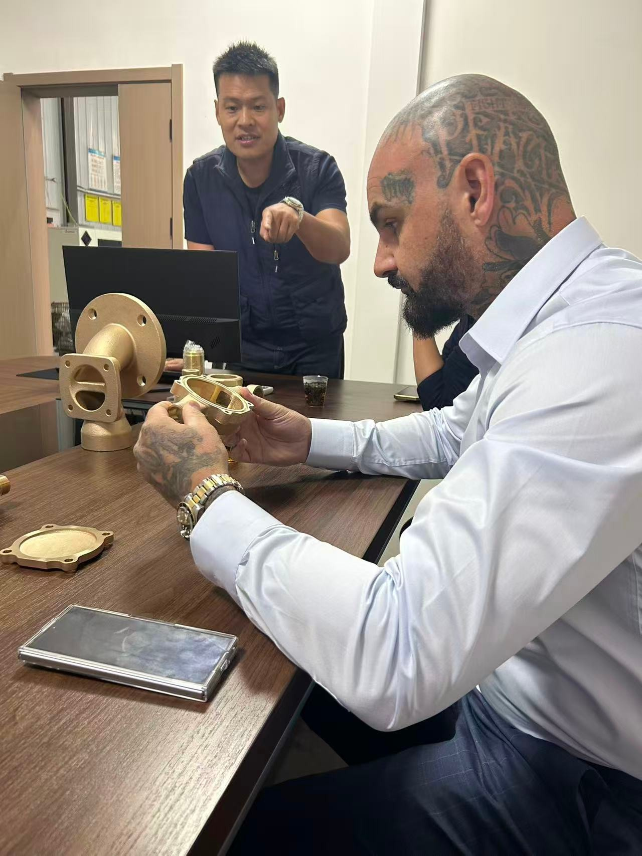 Chris Perfetti inspecting a first-article brass casting at a Shanghai foundry, China, 2025, Global Supply Network supplier audit.