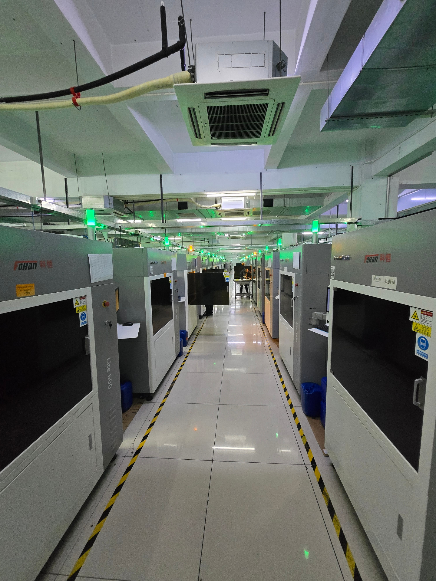 Production hall with rows of Fohan Lite 600 SLA / metal 3D printers at a Shenzhen 3D printing facility, China, 2024.